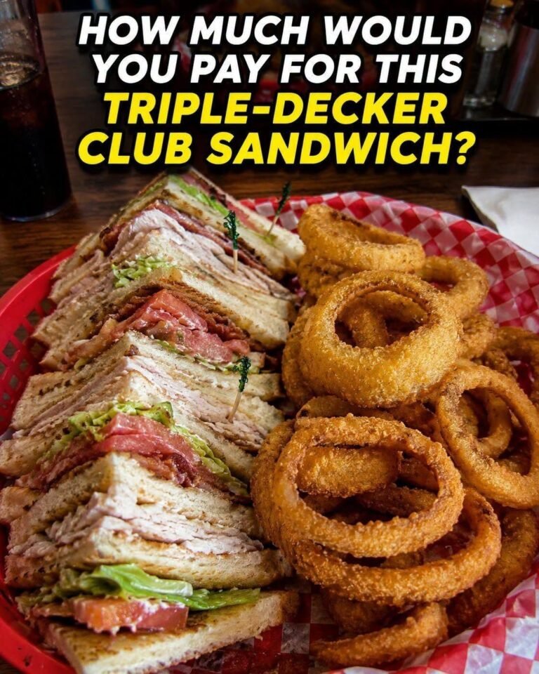 A massive turkey, ham, and bacon club sandwich stacked on toasted sourdough, served with a giant mountain of crispy beer-battered onion rings. What is a completely fair price for this classic diner lunch right now?